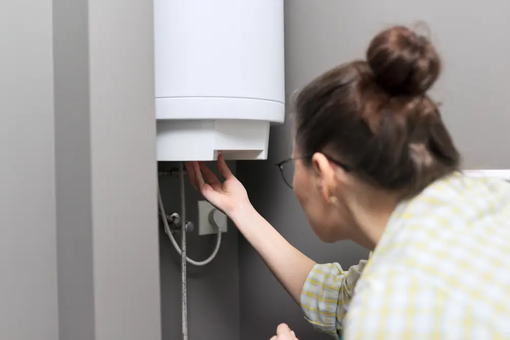 Water Heater - Woman adjusting water heater control